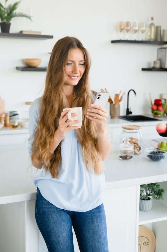 Vertical,Photo,Of,Young,Caucasian,Woman,Using,Smart,Phone,For